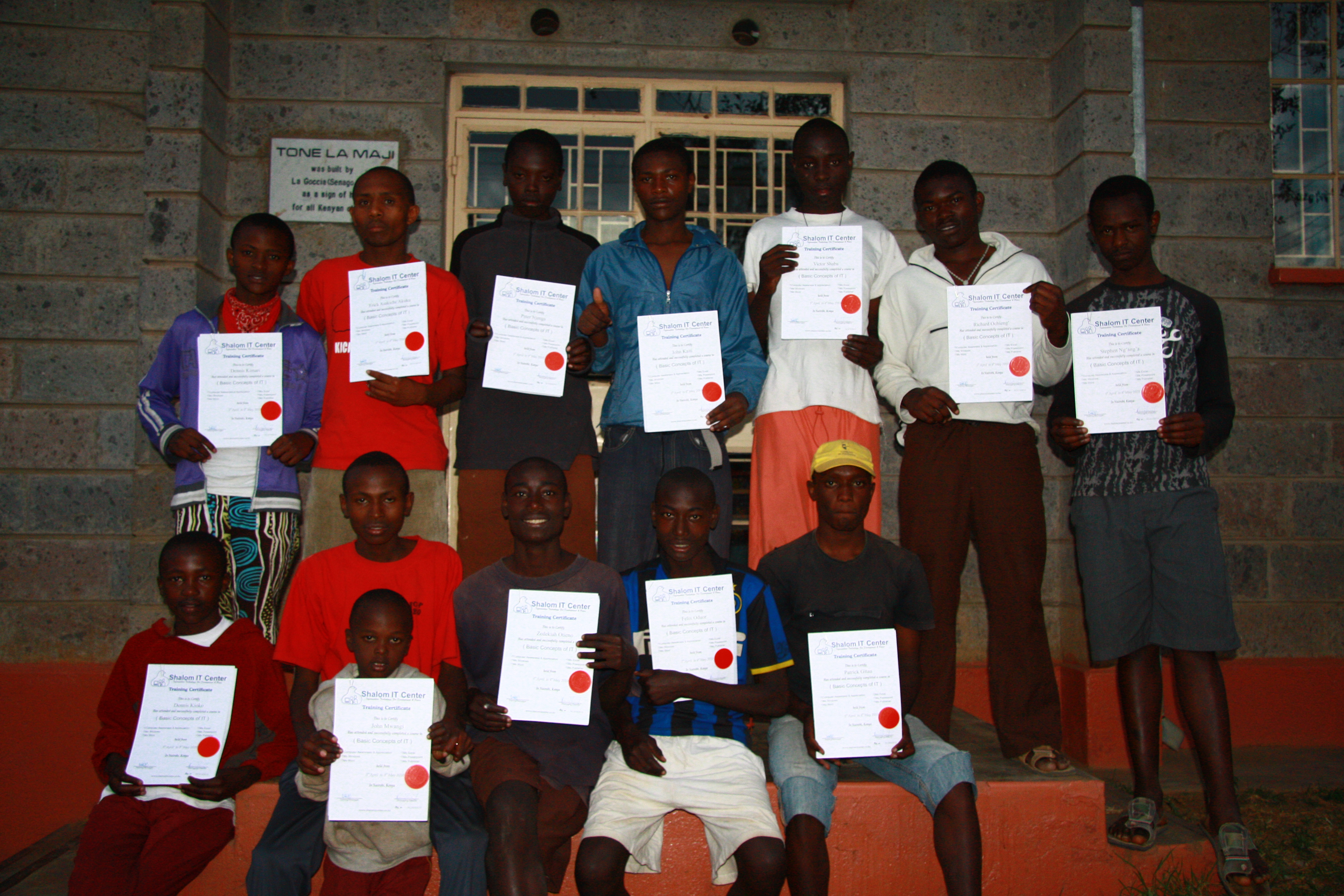 TLM boys showing their Certificates